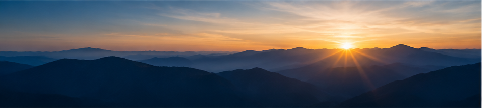 Sunrise over layered mountains